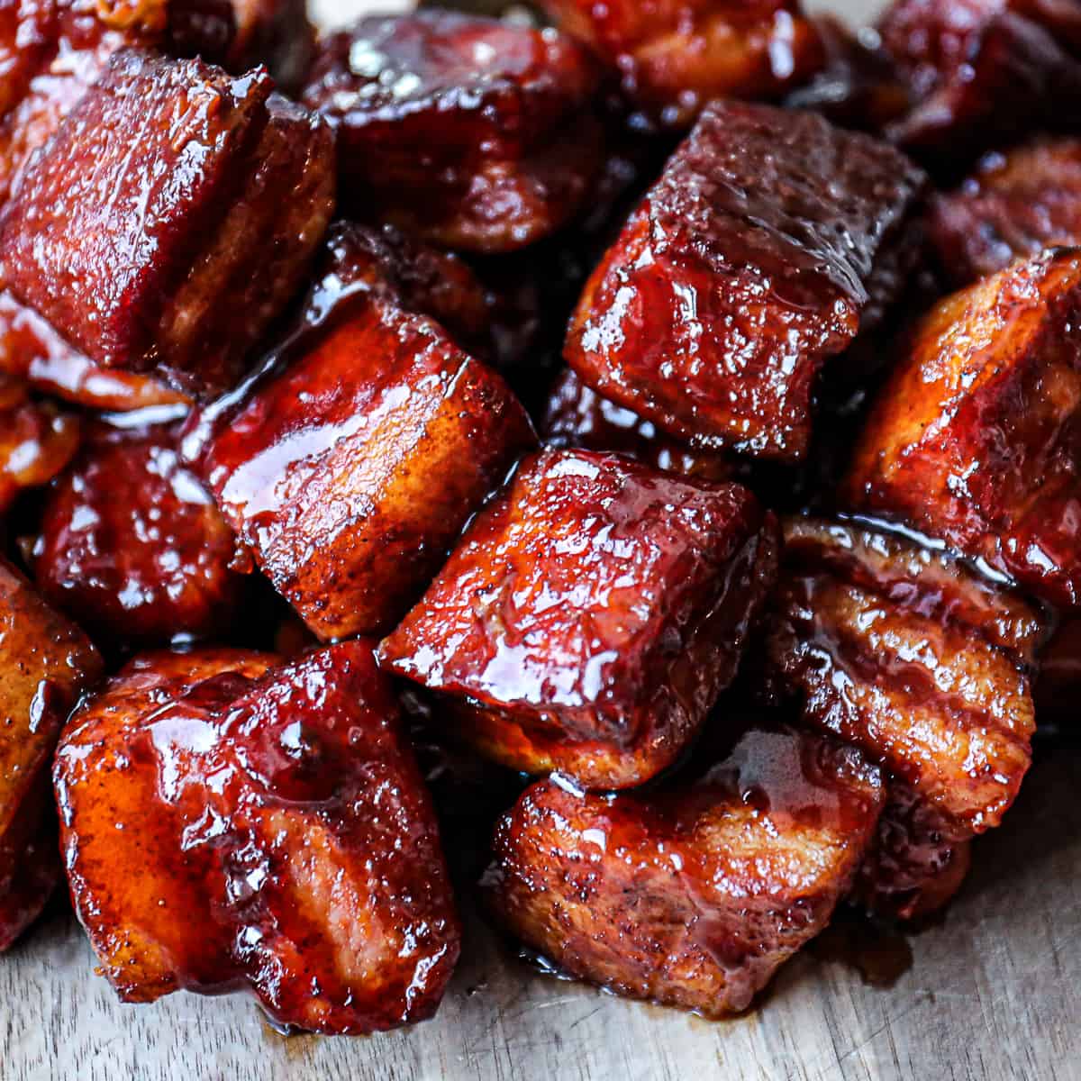Glazed pork belly bites with rich caramelized coating.
