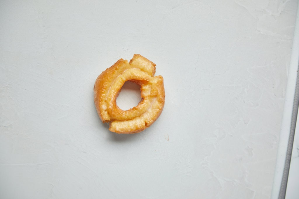 Glazed donut on white surface