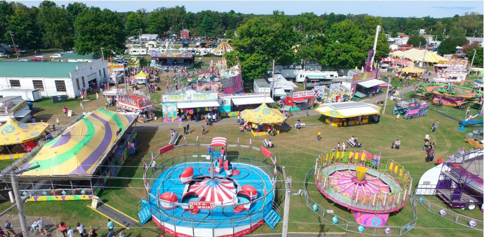 Aerial view of colorful amusement park with rides.