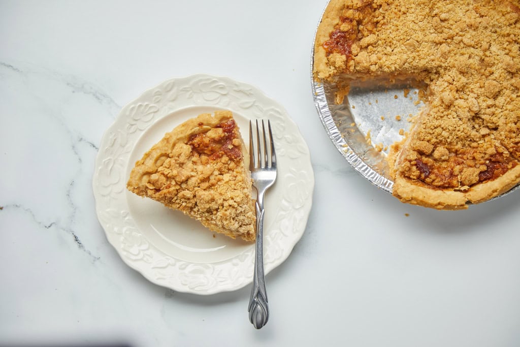 Slice of crumb-topped pie on plate.