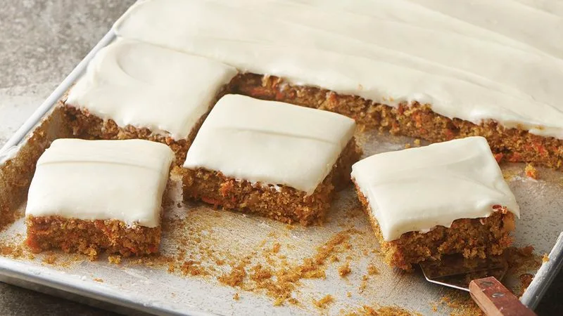 Carrot cake squares with cream cheese frosting.