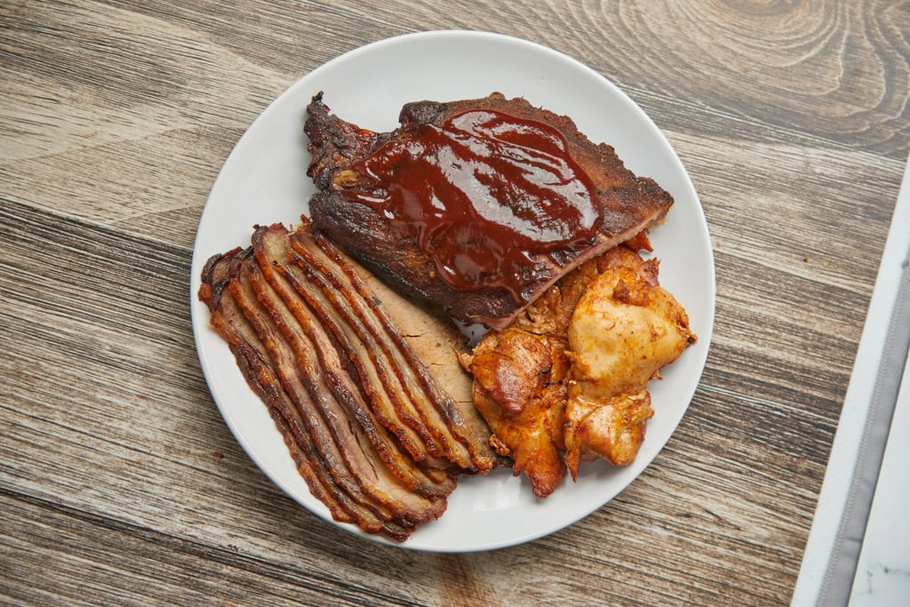 BBQ ribs, sliced brisket, chicken on plate