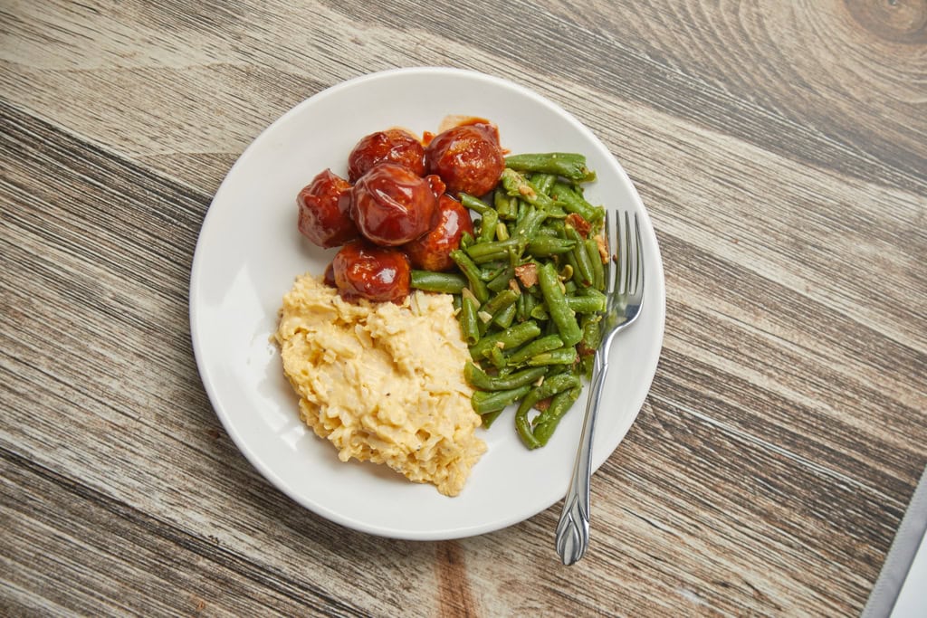 Plate with meatballs, green beans, mashed potatoes.