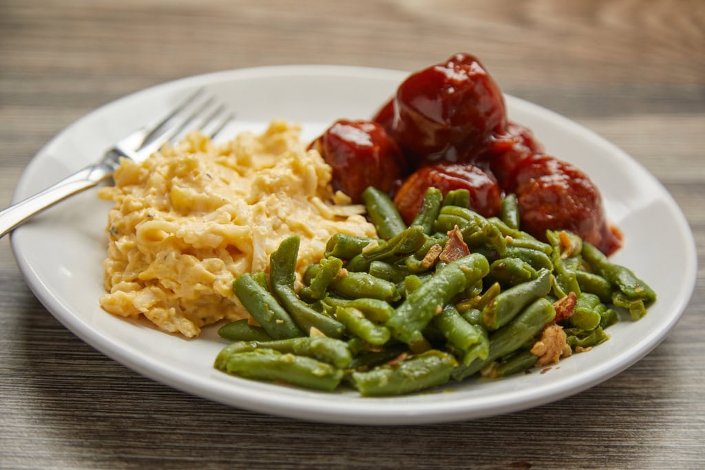 Plate with mac and cheese, meatballs, and green beans.