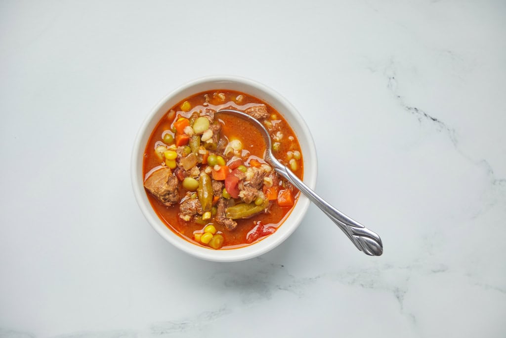 Bowl of vegetable beef soup with spoon