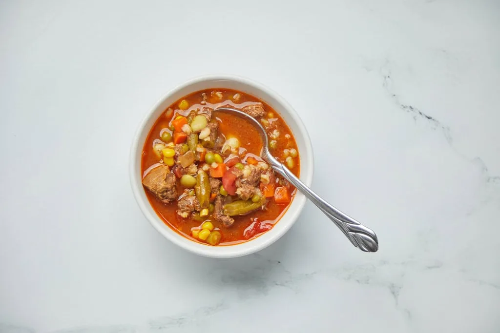 Bowl of vegetable beef soup with spoon