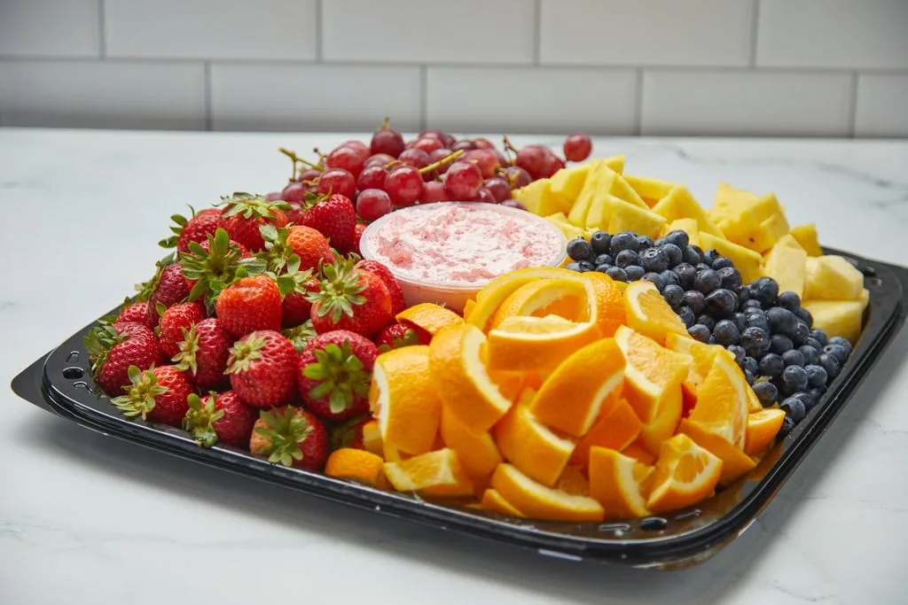 Assorted fresh fruit platter with dip.