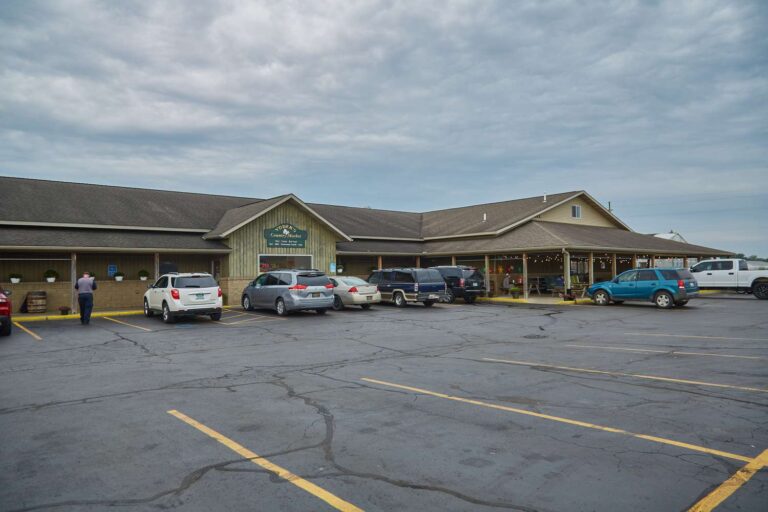 Parking lot outside a country market building.