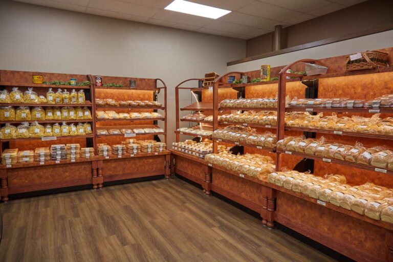 Bakery shelves filled with assorted breads and pastries.
