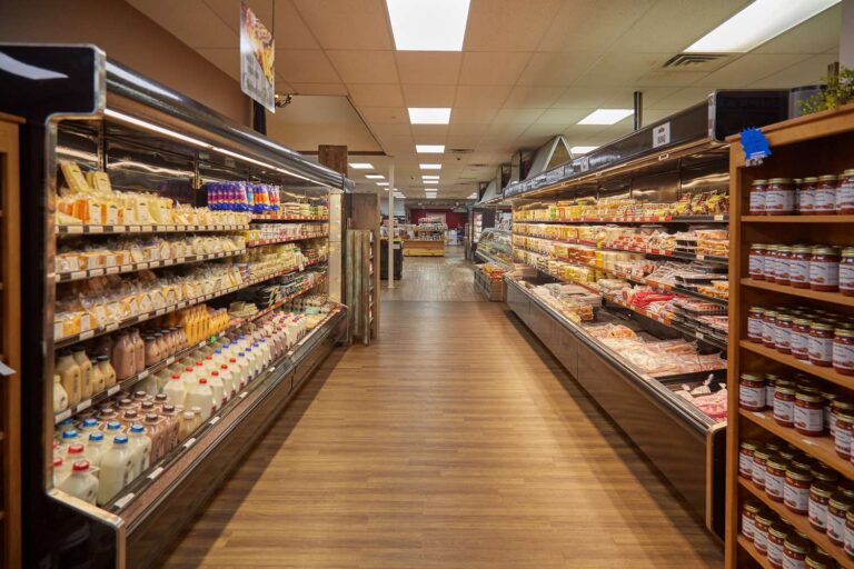 Grocery store aisle with dairy and deli products.